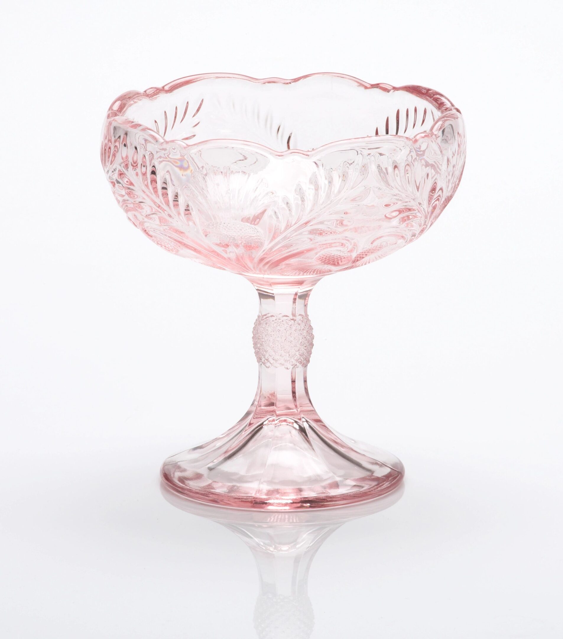 Elegant pink glass dessert bowl with intricate floral patterns.