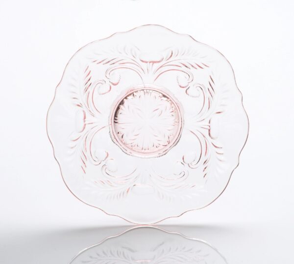Transparent glass plate with intricate floral etching and scalloped edges.