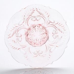 Elegant clear glass plate with intricate pink floral and swirl patterns.