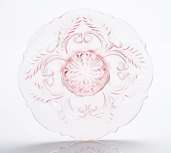 Elegant clear glass plate with intricate pink floral and swirl patterns.