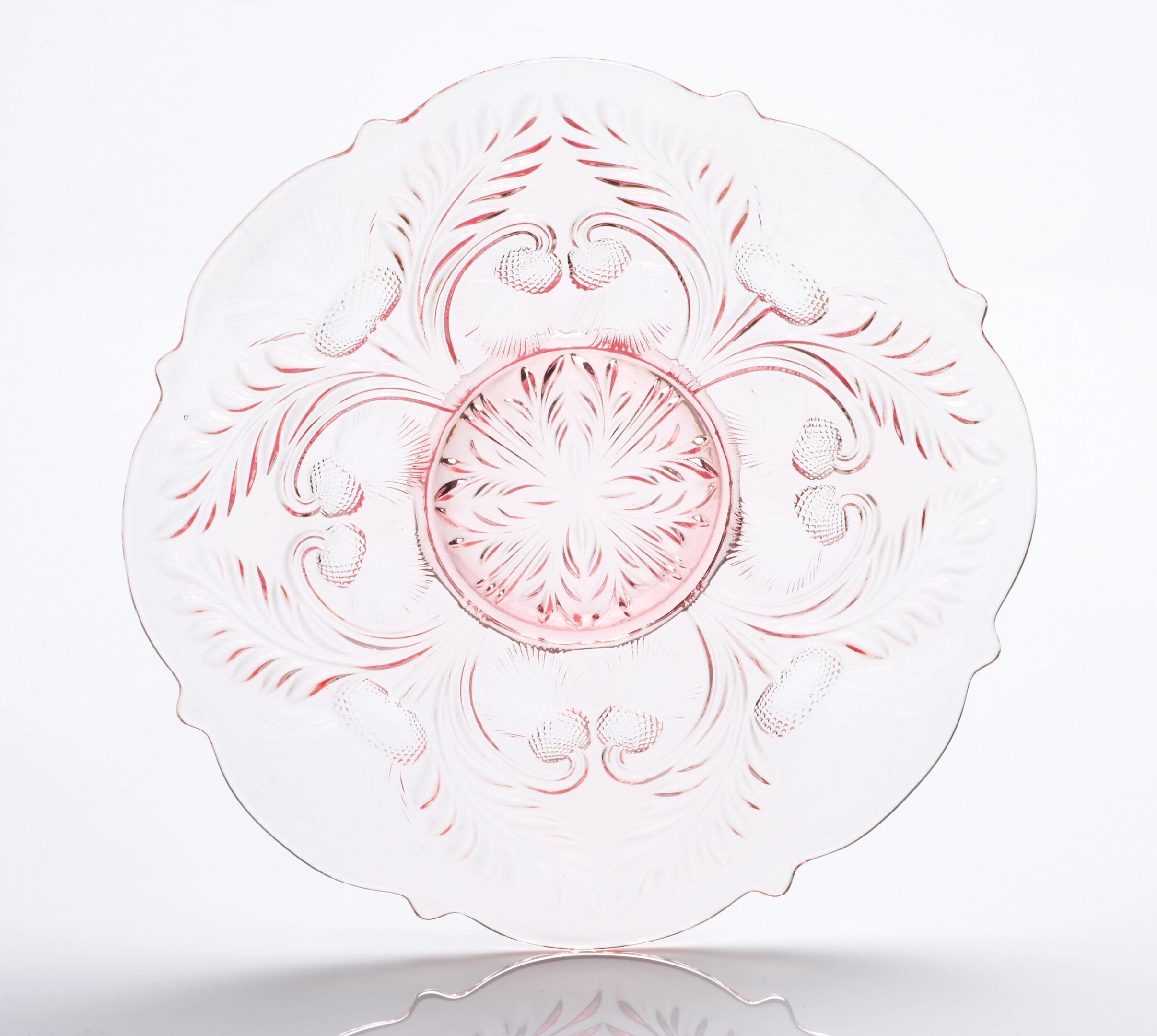 Elegant clear glass plate with intricate pink floral and swirl patterns.