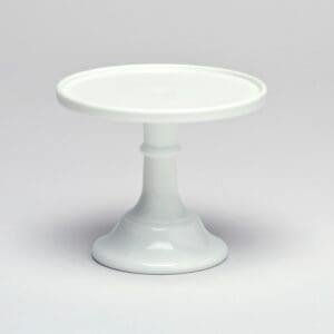 White ceramic cake stand with a simple pedestal base.