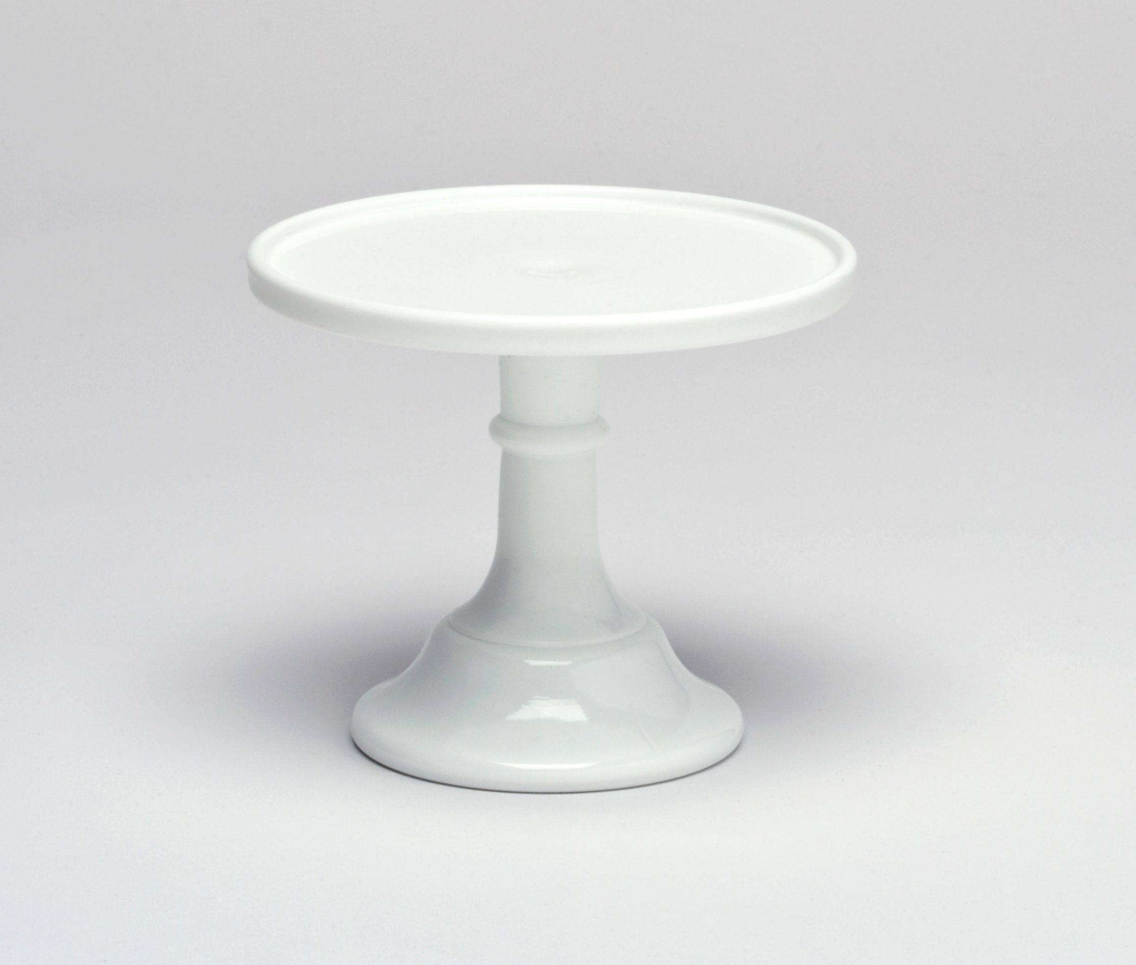 White ceramic cake stand with a simple pedestal base.