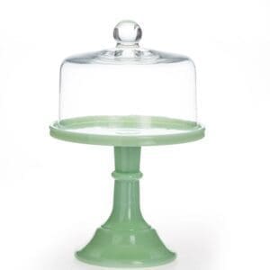 Green cake stand with a glass dome cover.