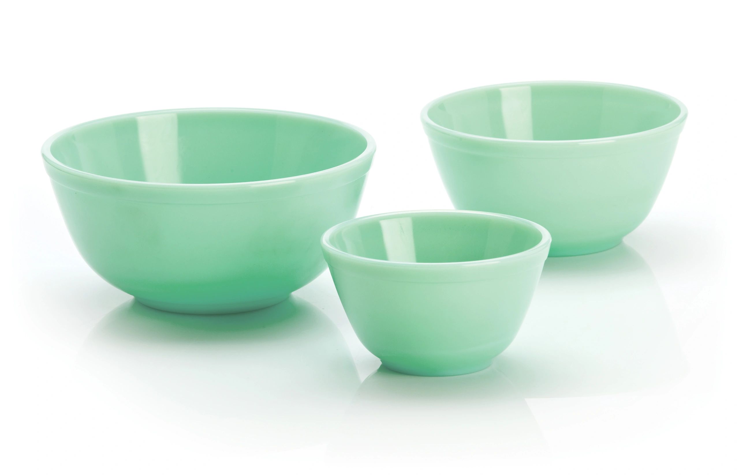 Three mint green ceramic bowls of varying sizes.