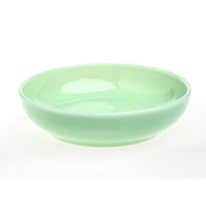 A smooth, light green ceramic bowl with a glossy finish.