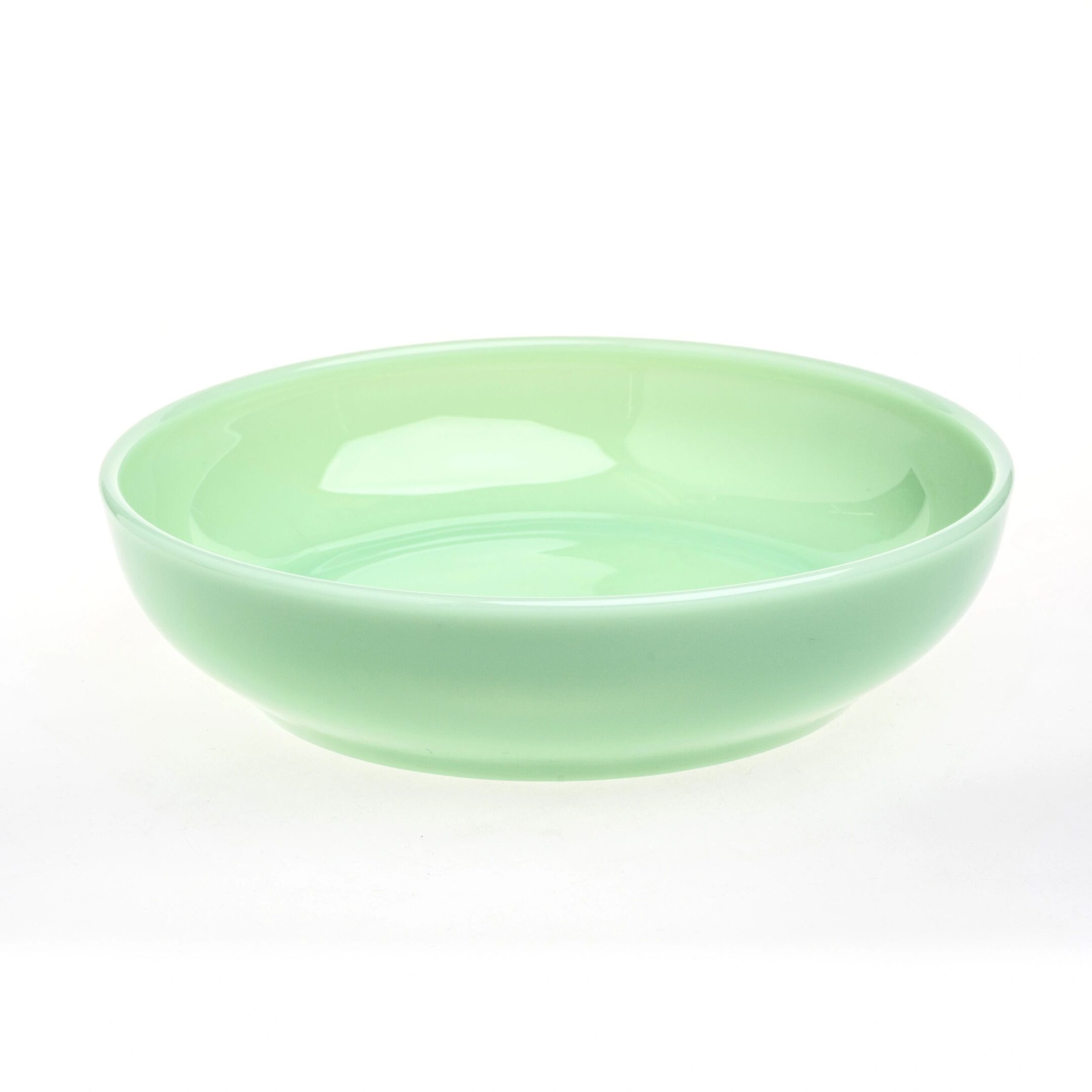 A smooth, light green ceramic bowl with a glossy finish.