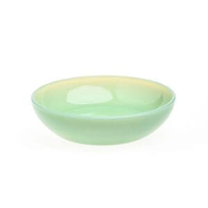A small, round, pale green ceramic bowl with a glossy finish.