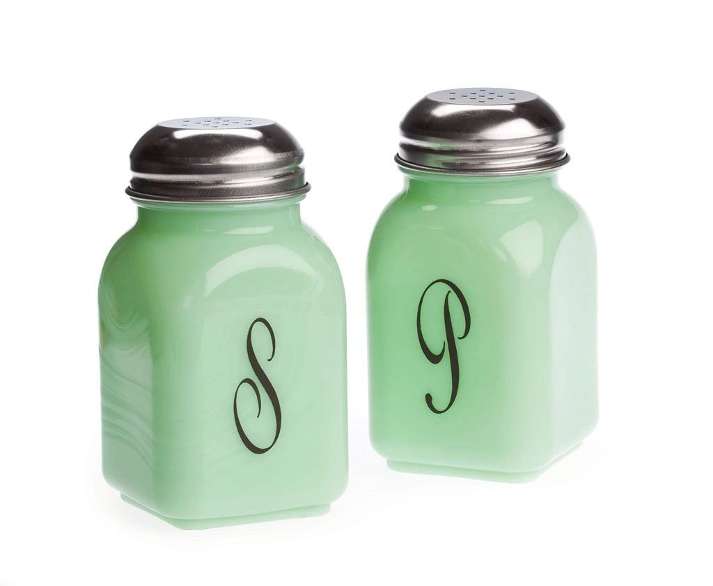 Vintage green glass salt and pepper shakers with silver tops.