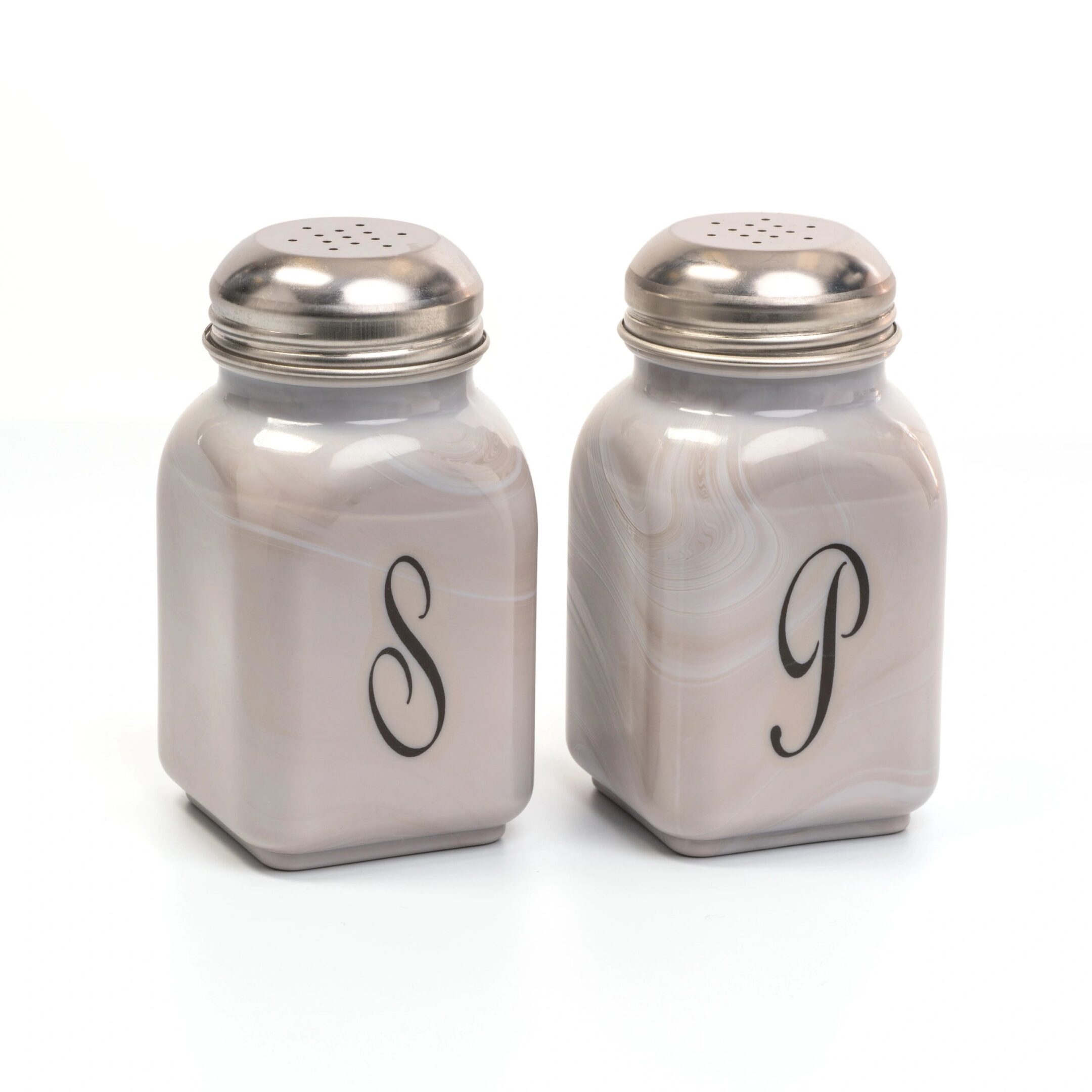 Two metallic salt and pepper shakers with engraved letters S and P.