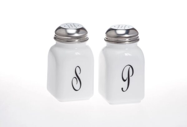 White ceramic salt and pepper shakers with silver tops and initials S and P.