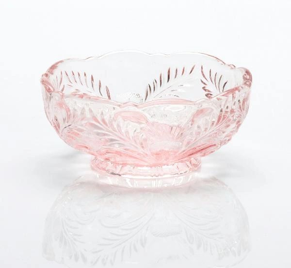 Elegant pink glass bowl with intricate leaf patterns.