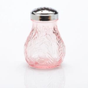 A pink glass sugar shaker with a metal lid.