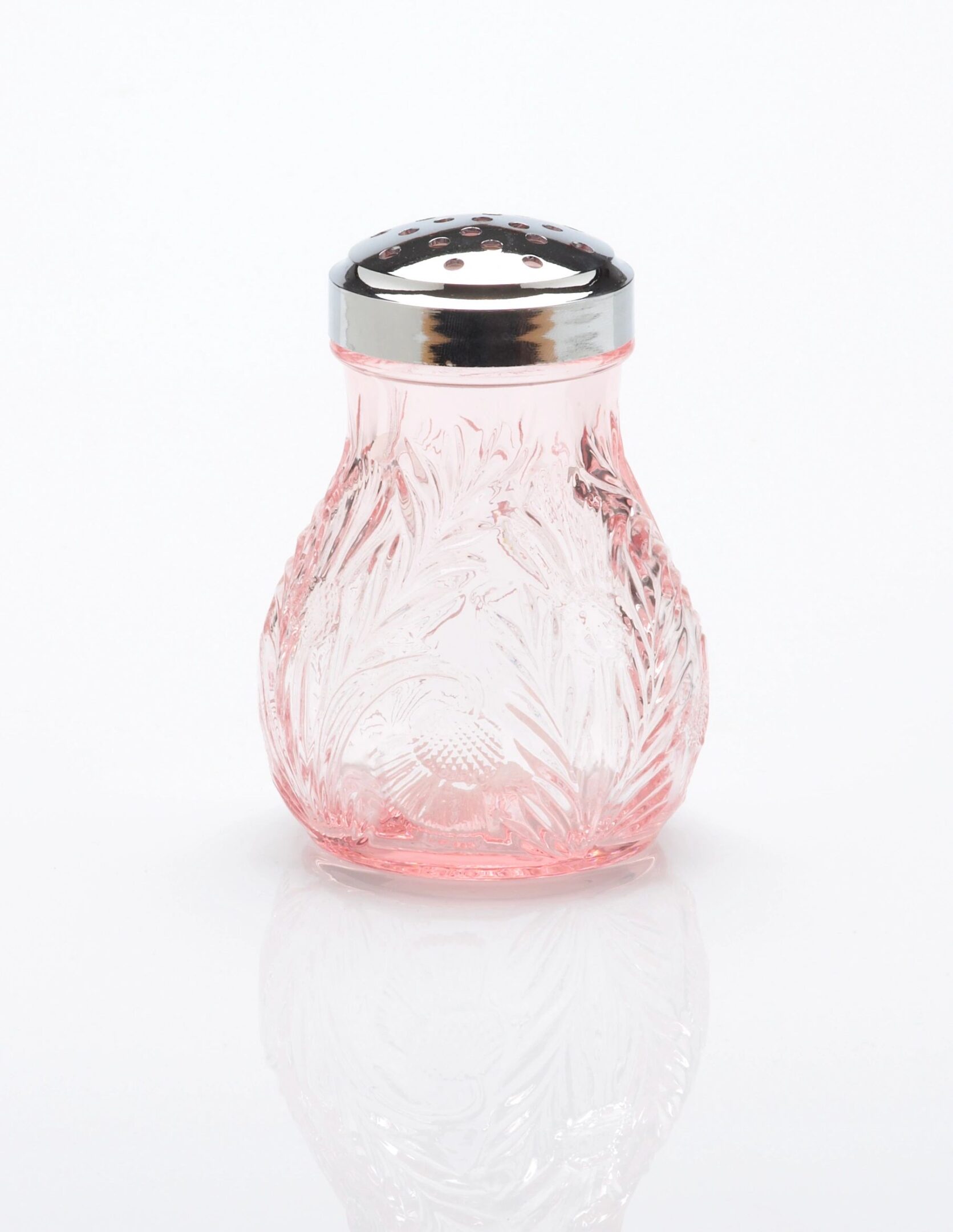 A pink glass sugar shaker with a metal lid.