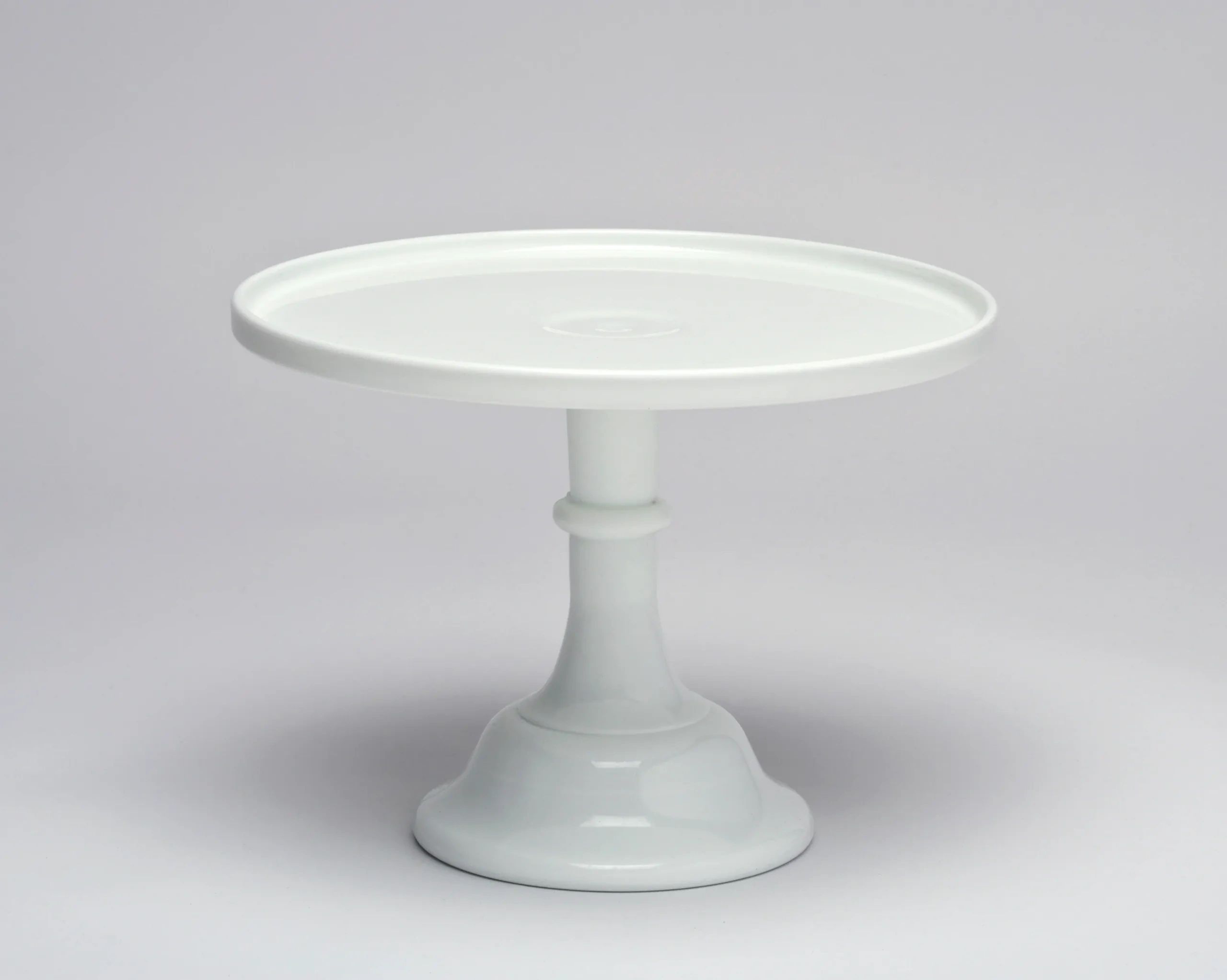 White ceramic cake stand with a pedestal base.