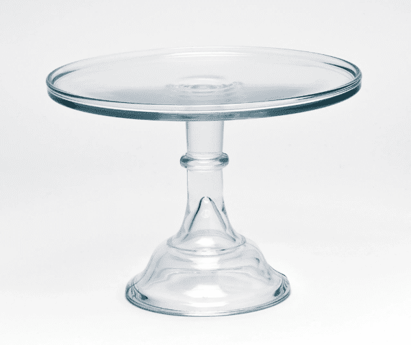 A clear glass cake stand with a pedestal base.