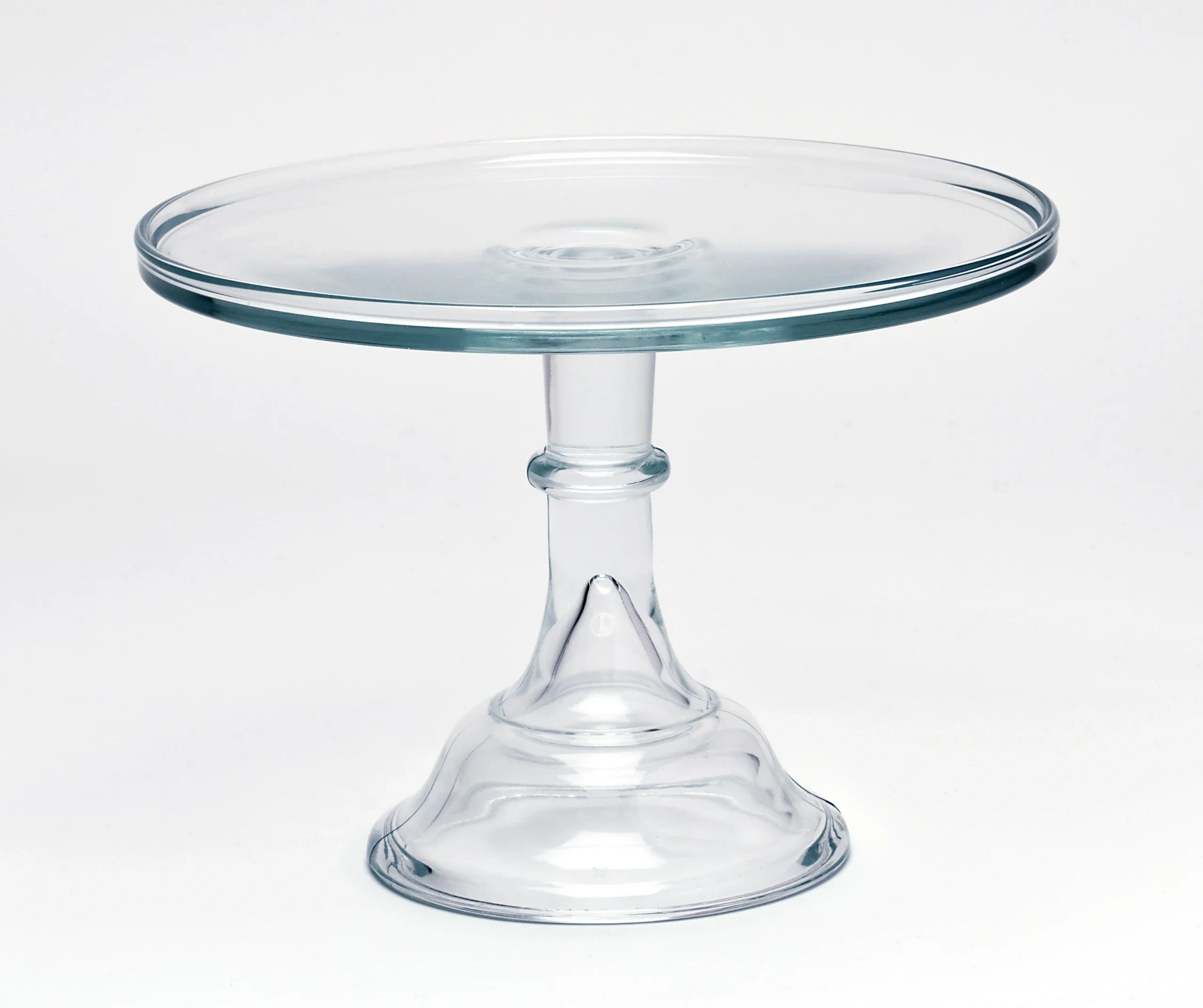 A clear glass cake stand with a pedestal base.