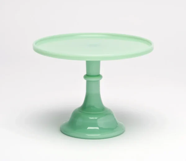 Elegant green glass cake stand with a pedestal base.
