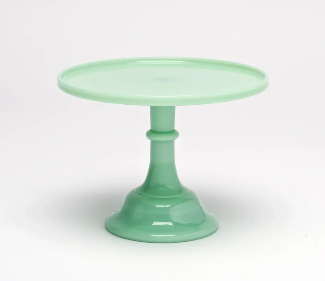 Elegant green glass cake stand with a pedestal base.
