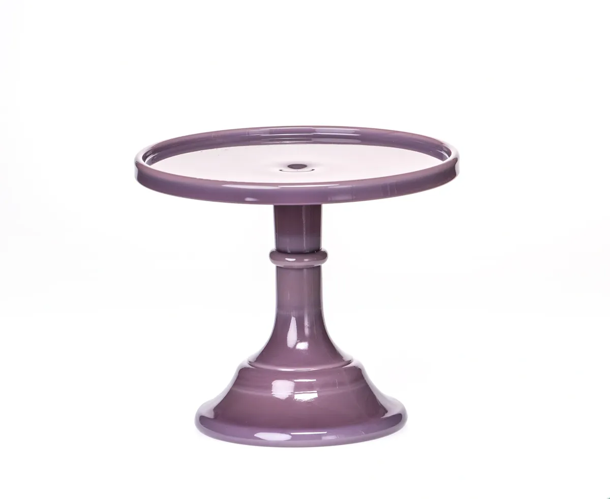 Purple ceramic cake stand with a pedestal base.