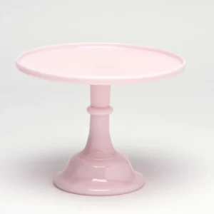 Elegant pink cake stand with a scalloped edge and pedestal base.