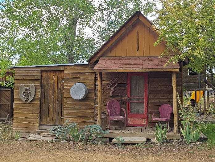 Quaint cabin porch with two pink chairs